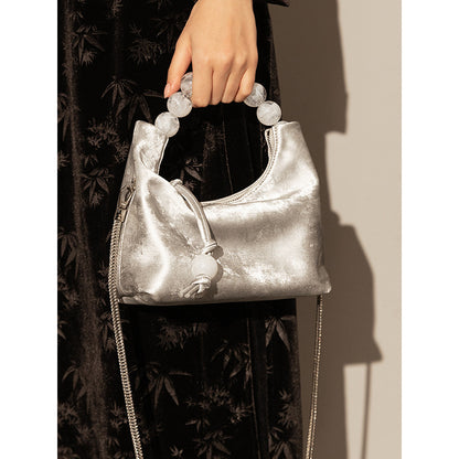 Sac à main à bandoulière avec chaîne en perles et bandoulière de niche
