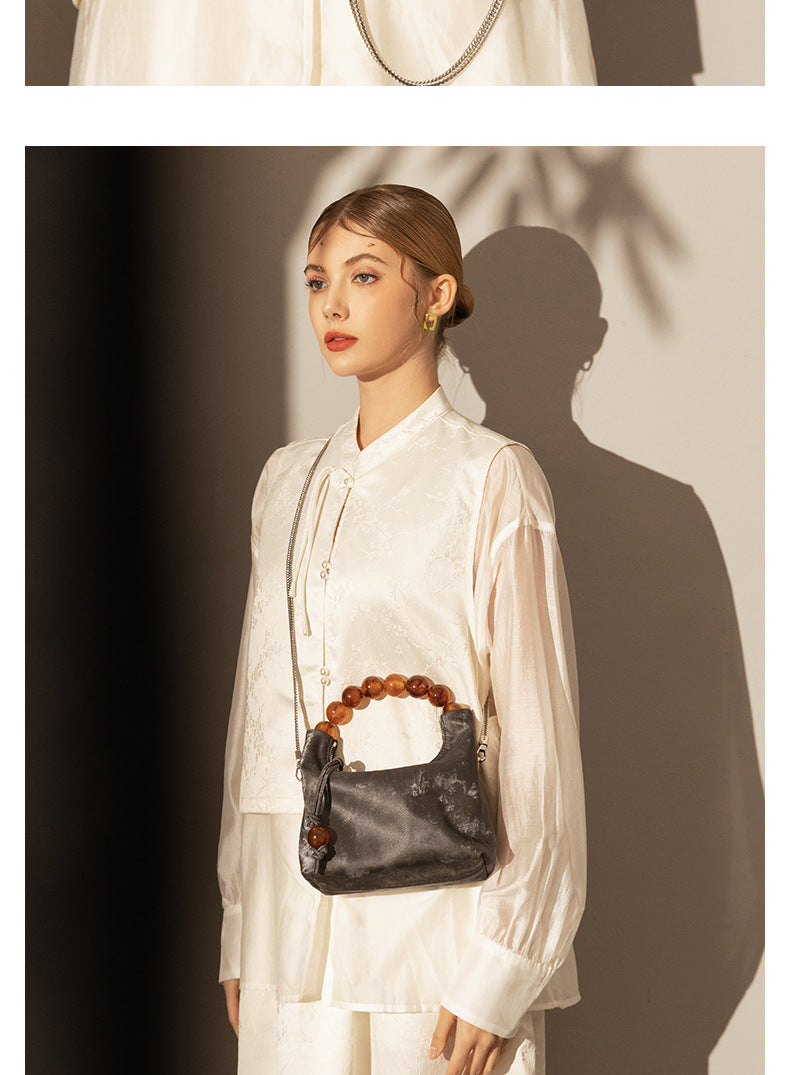 Sac à main à bandoulière avec chaîne en perles et bandoulière de niche