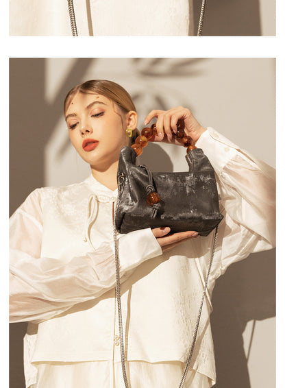 Sac à main à bandoulière avec chaîne en perles et bandoulière de niche