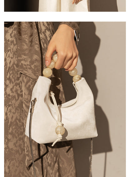 Sac à main à bandoulière avec chaîne en perles et bandoulière de niche